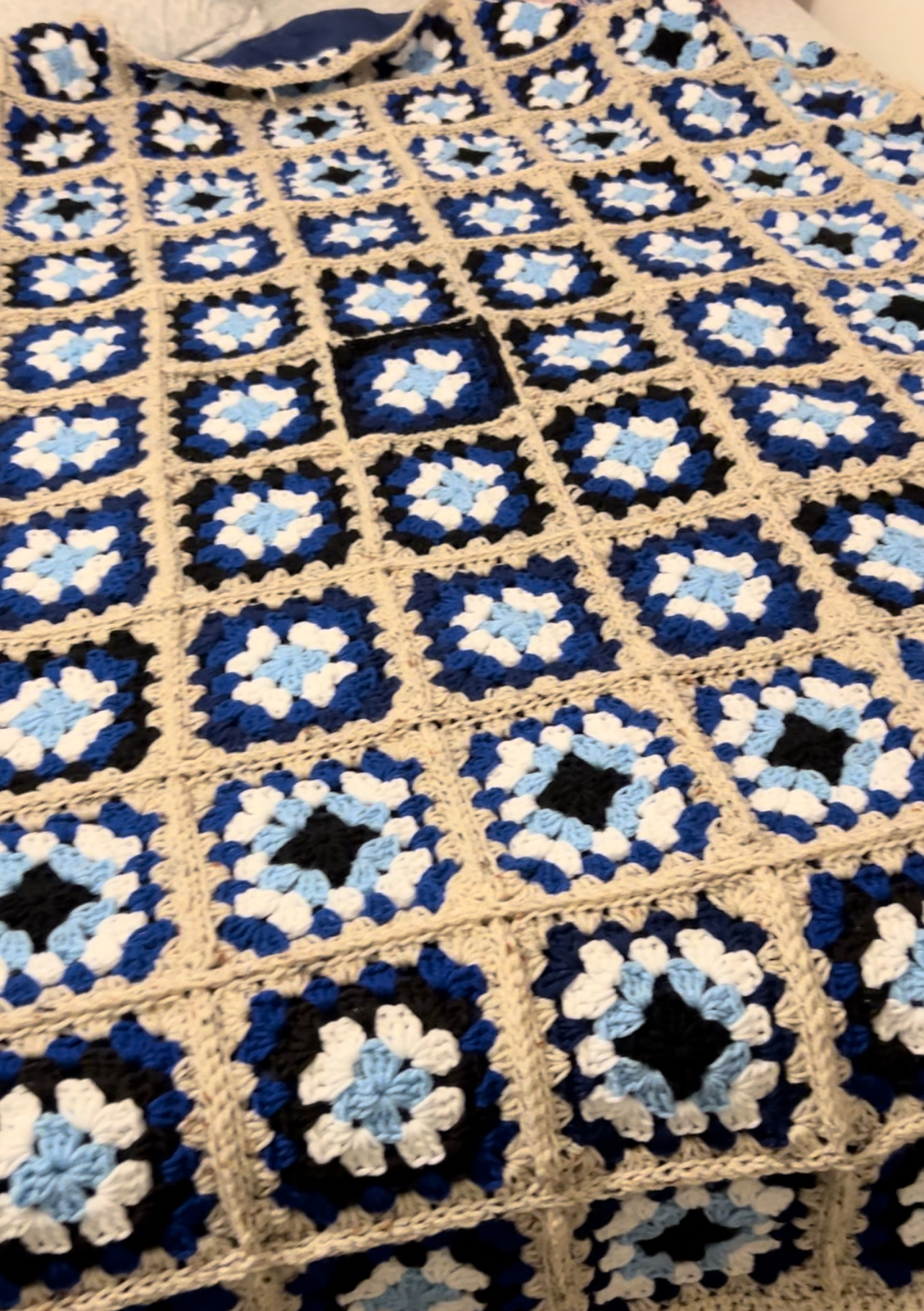 Colorful handmade crochet blanket with an eye motif